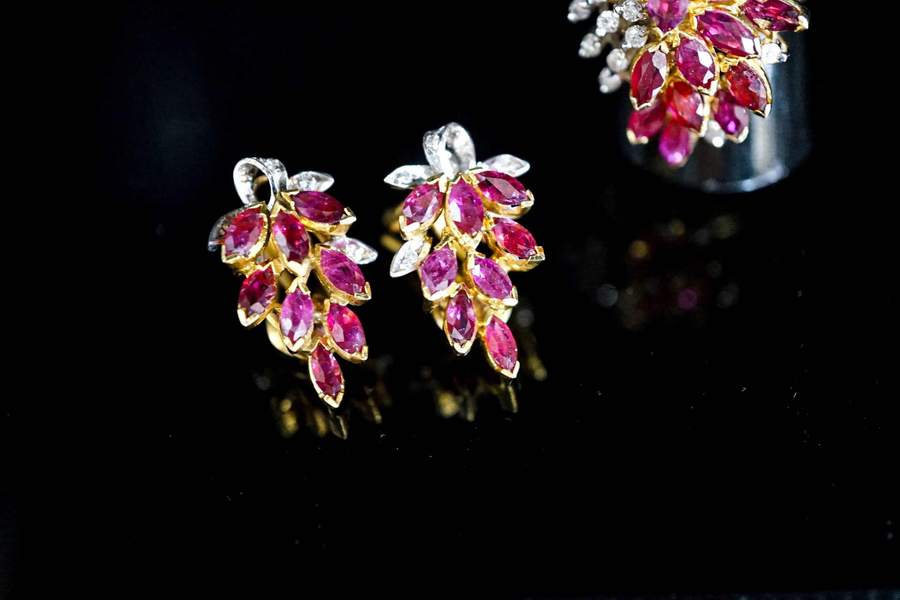 A modern 585 yellow metal, ruby and diamond cluster dress ring, size T and a pair of matching earrings, gross 14.1 grams.